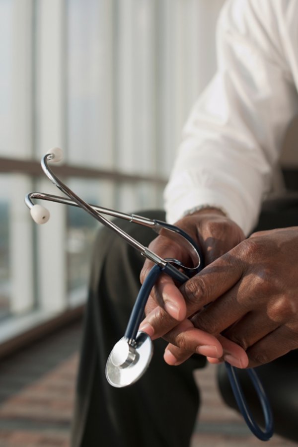 Doctor holding stethoscope in both hands