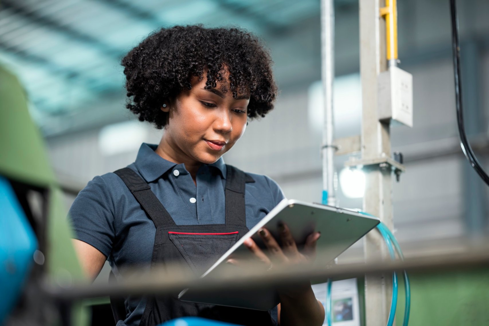 Curly haired woman using tablet