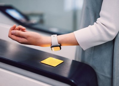 A person using a smartwatch to pay