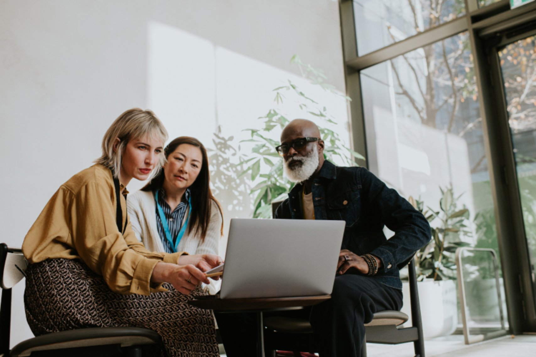 Three people in front of laptop