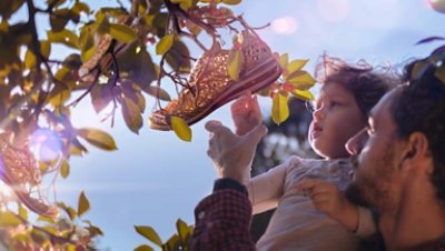 Father and child shoes hanging tree