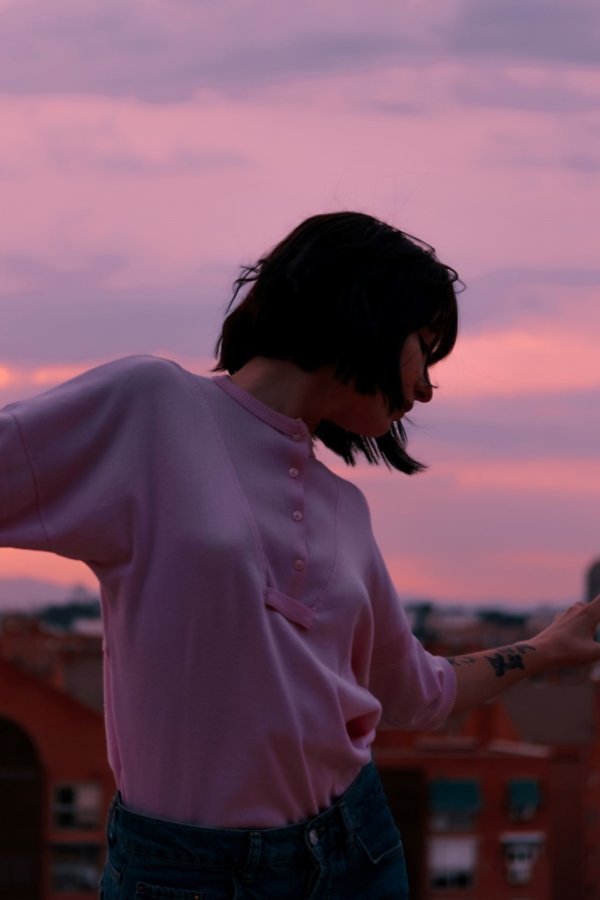 A women with his arms outstretched on a sunset