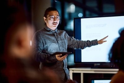 hot of a young businessman delivering a presentation during a late night meeting at work