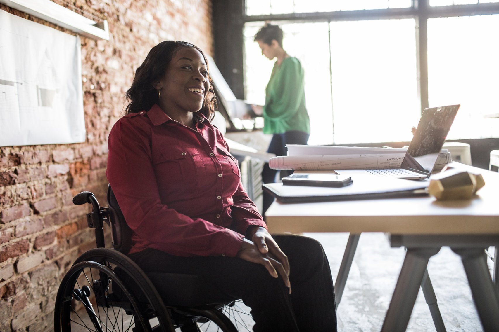 Businesswoman in wheelchair working at desk