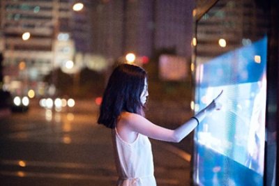 Girl touching big screen