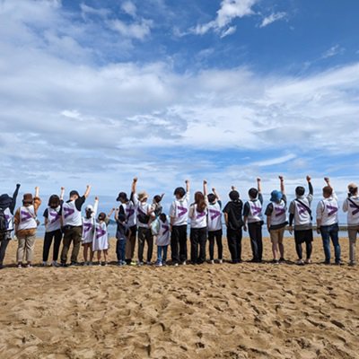 Group of people showing accenture logo on their shirts at the back