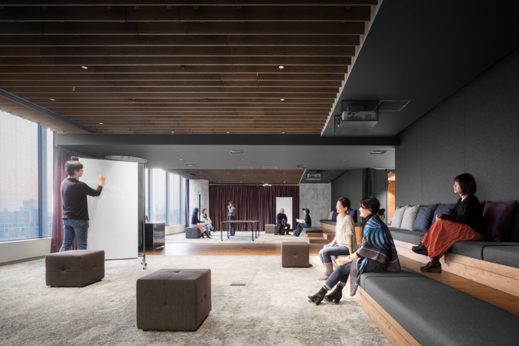 Guy in black sweater writing on the whiteboard