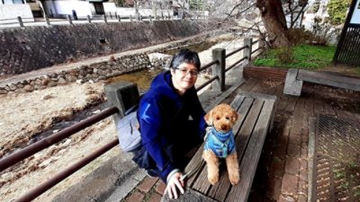 Guy in blue jacket with dog