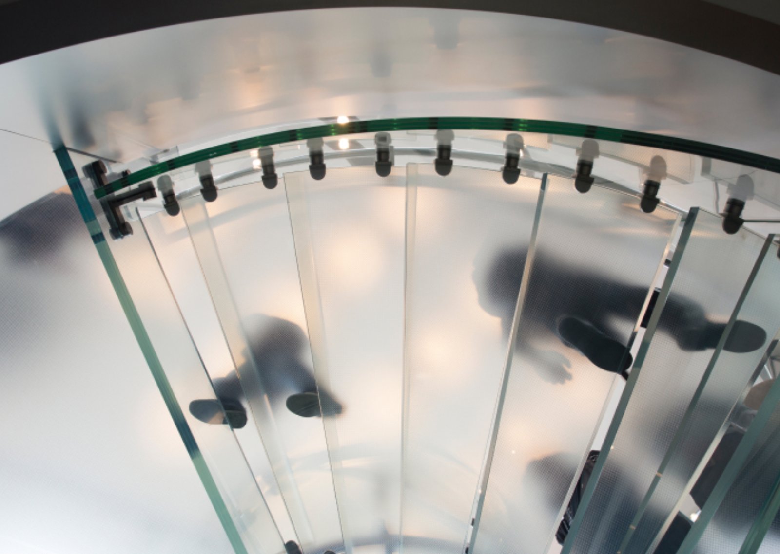 A foot steps against a sky background on a clear staircase