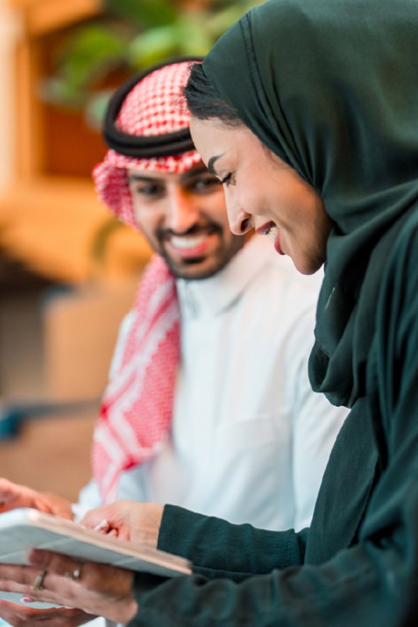 Middle Eastern professionals collaborating with tablet device