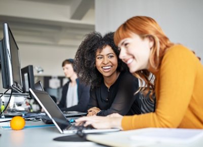 Ladies chatting while using computer