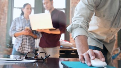 Man Hand on the Mouse Focus withMman Holding Laptop while Standing with a Woman