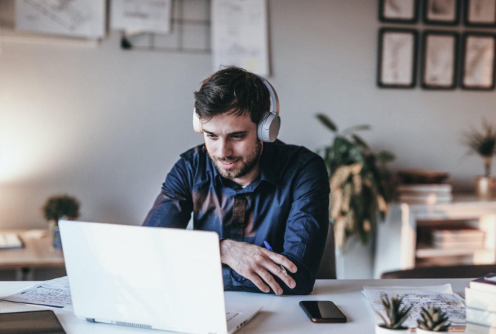  Man in front of laptop with headphones