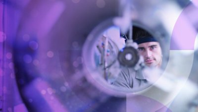 Picture of a Man Looking Through a Scientific Machine