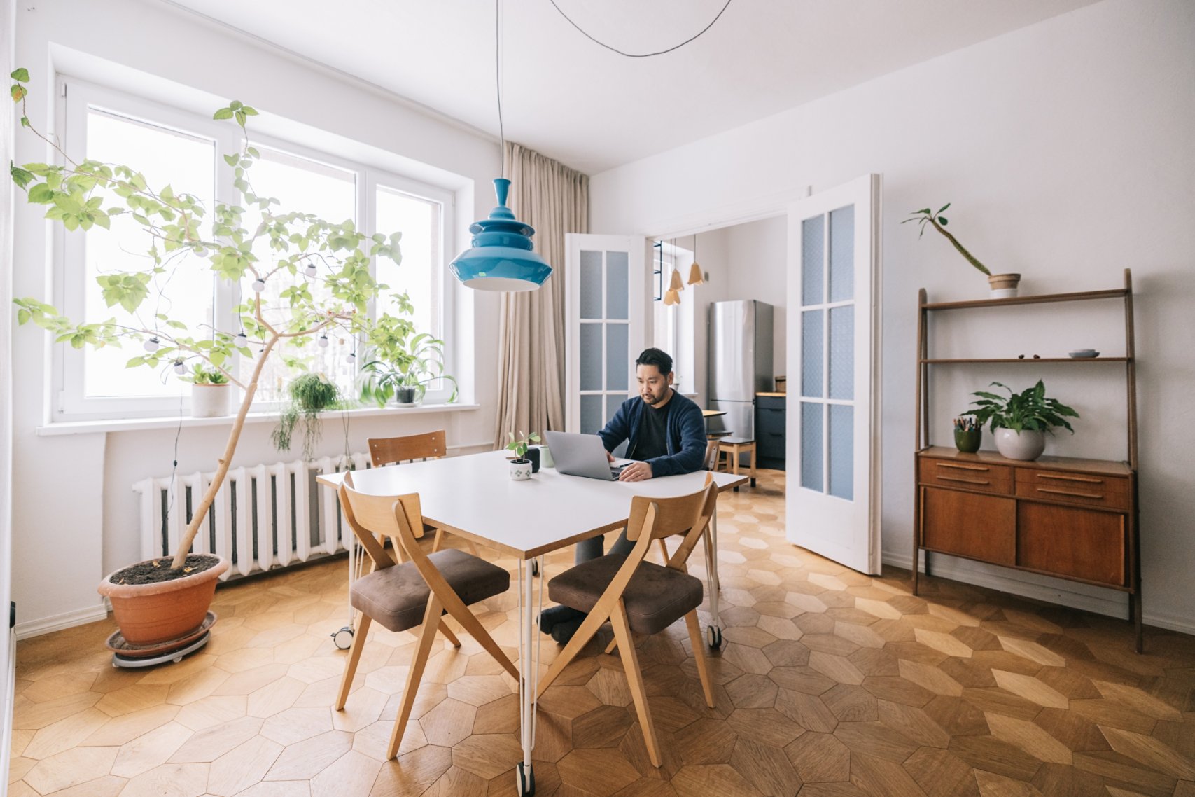 Man in his home office while using laptop