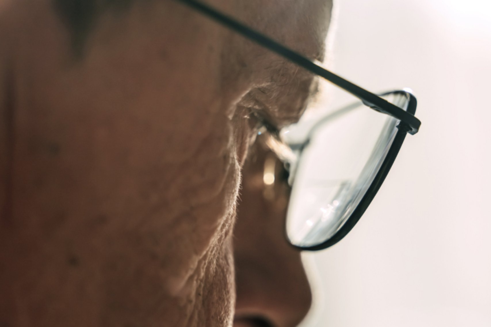 Man in sideview wearing glasses