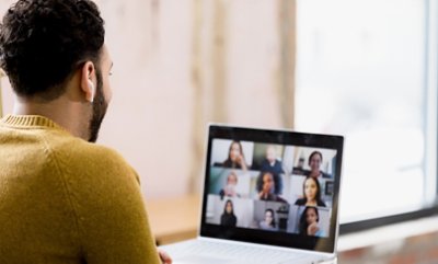 Man wearing mustard color sweatshirt videocall