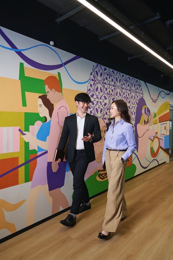 Man and woman walking in office hallway