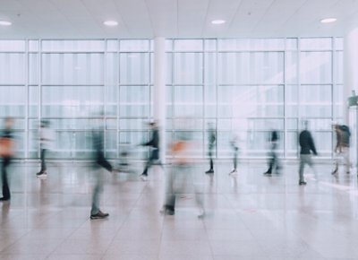 People Walking in a Hallway in Motion