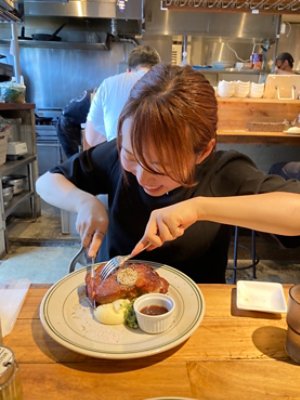 A woman cutting on a steak