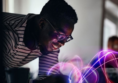 Person using a technological device with neon lights.