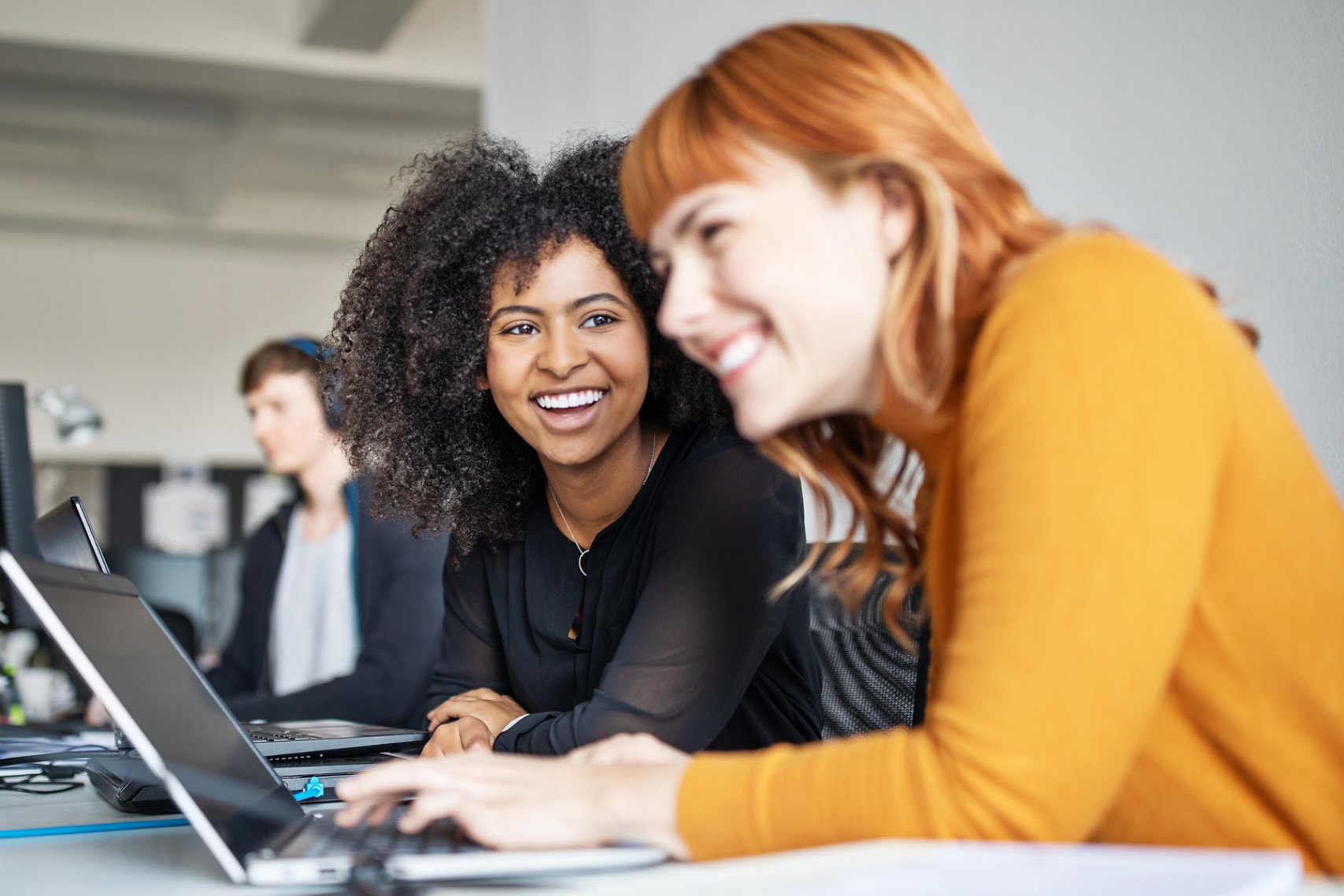 Two female colleagues in office working together.
