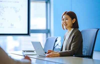 Sachiho in a meeting with her laptop