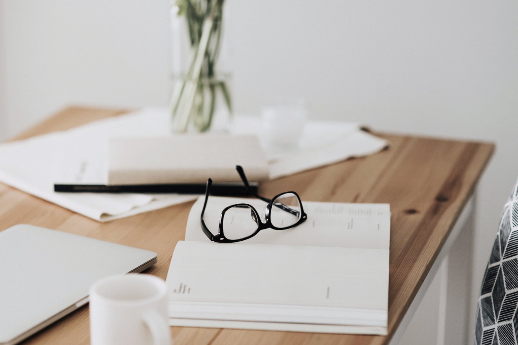 Notebook and glasses on table