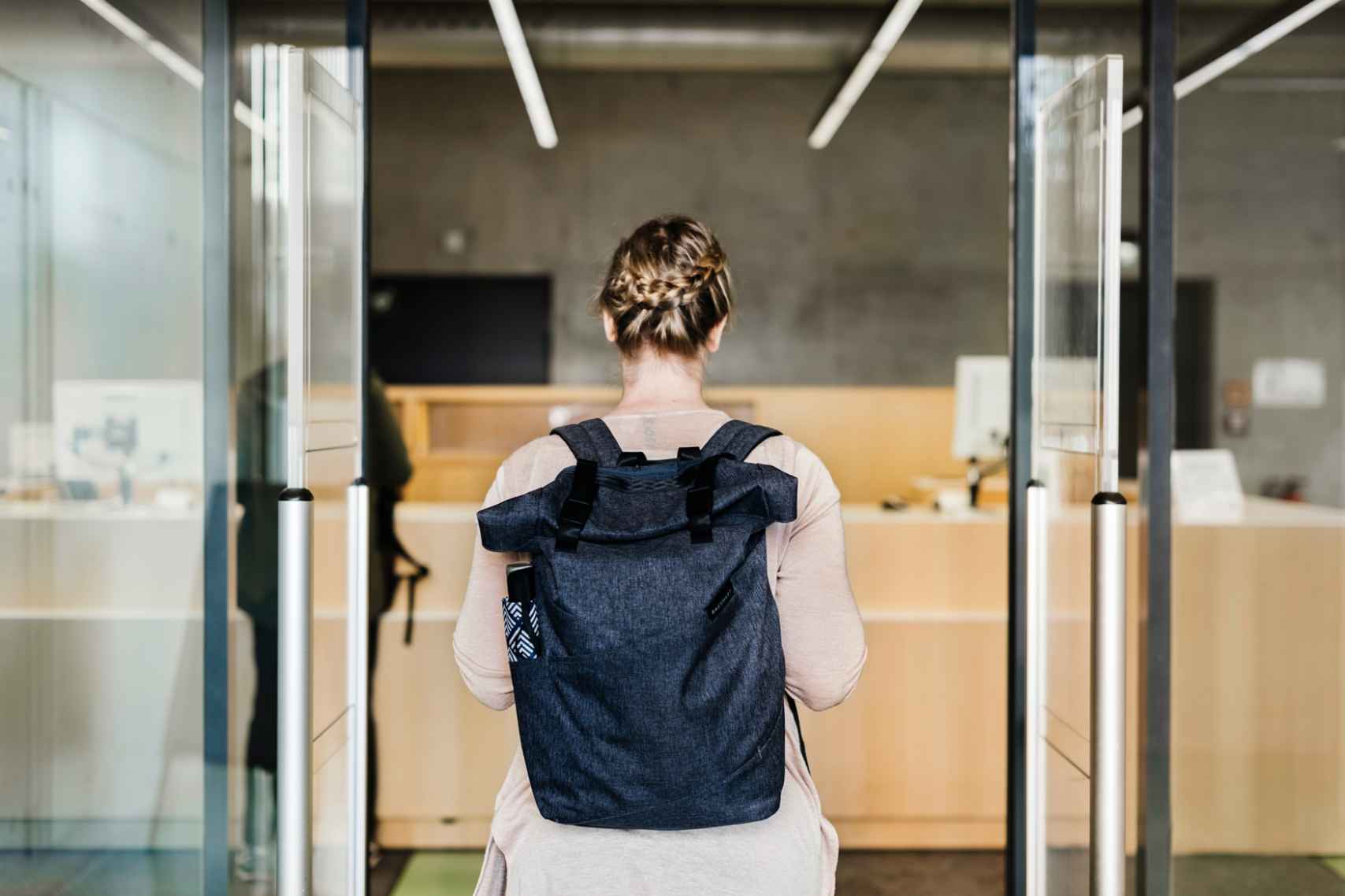 Woman Walking Through Library Entrance