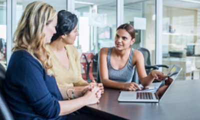 Three Women Discussing with a Laptop