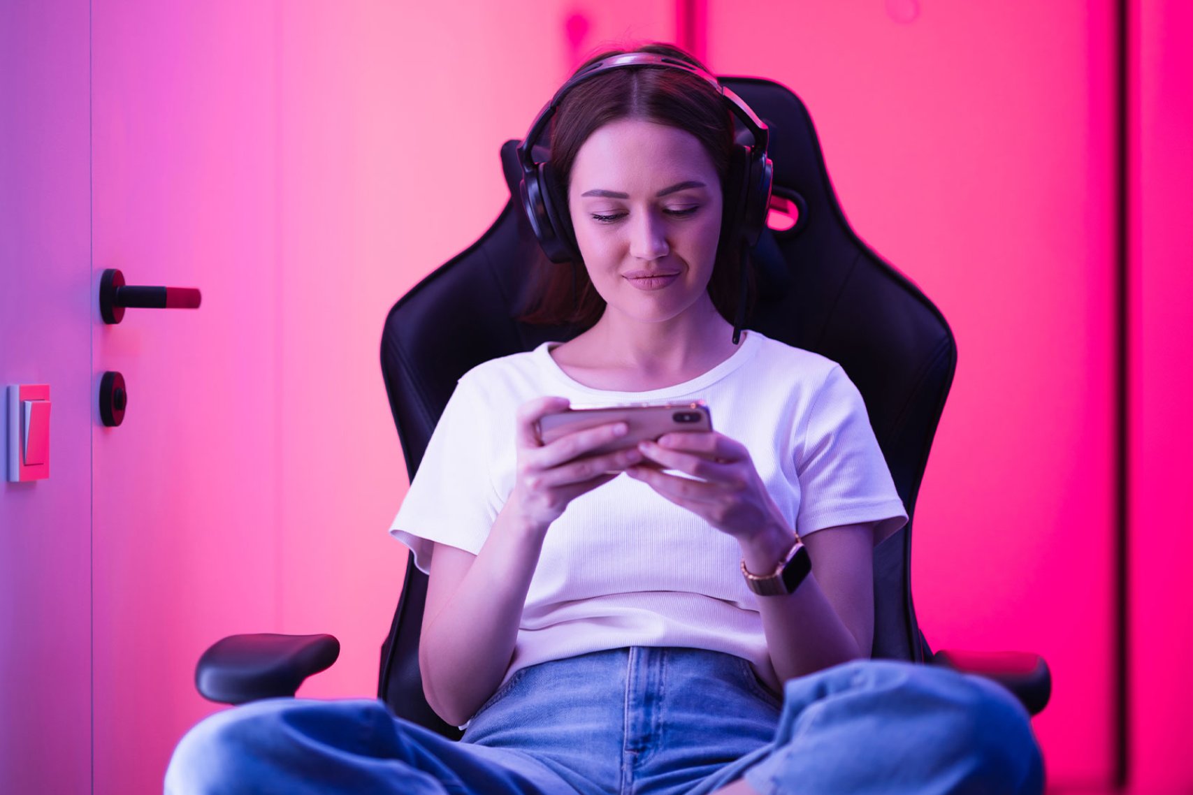 A woman playing mobile games in her home