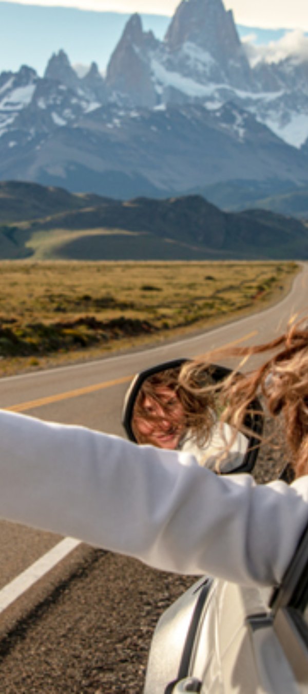 Woman driving hand out the window.