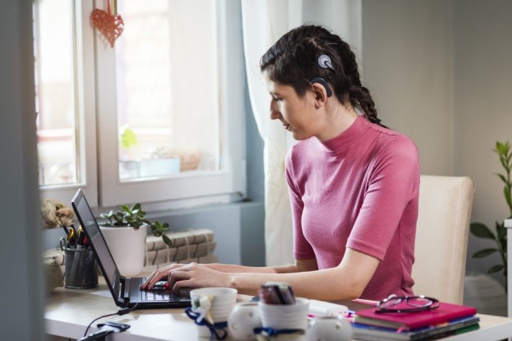 Woman in pink blouse sitting