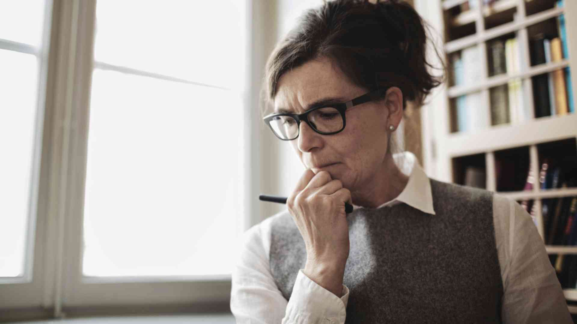 Woman with glasses hand on chin