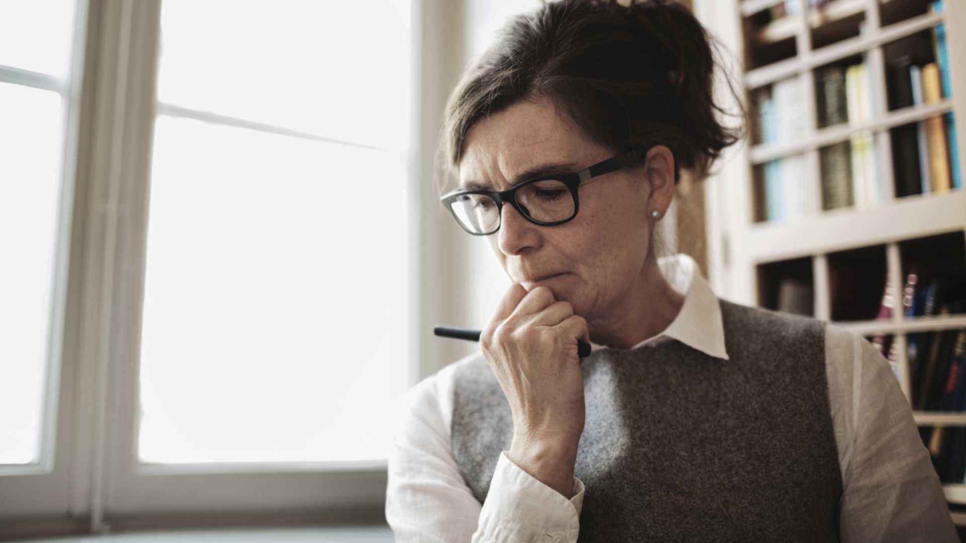 Woman with glasses hand on chin