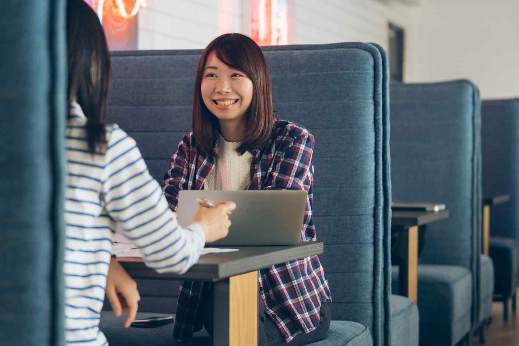 Two young women having a meeting in a modern share office. Tokyo, Japan. March 2018