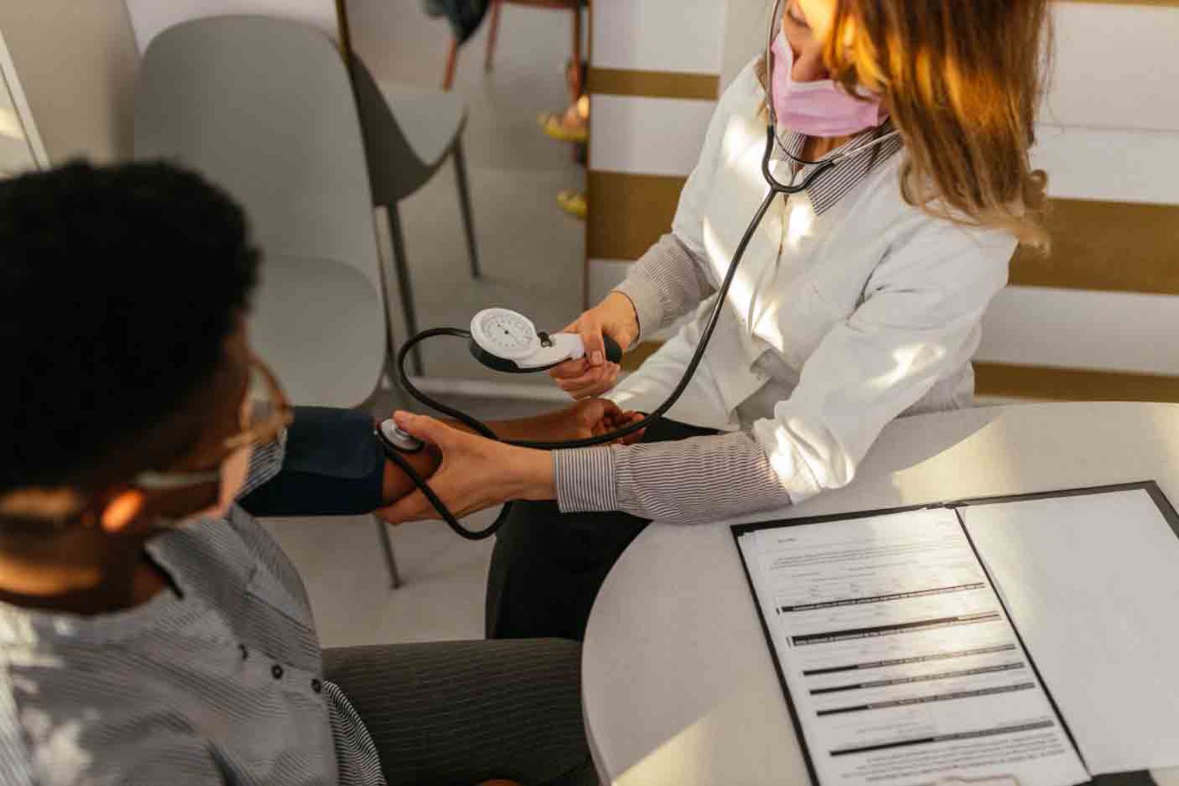 A doctor checking the blood pressure of a patient