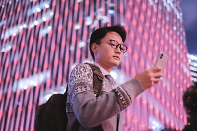  Young Asian Business Man using Smartphone in Financial District of Shanghai