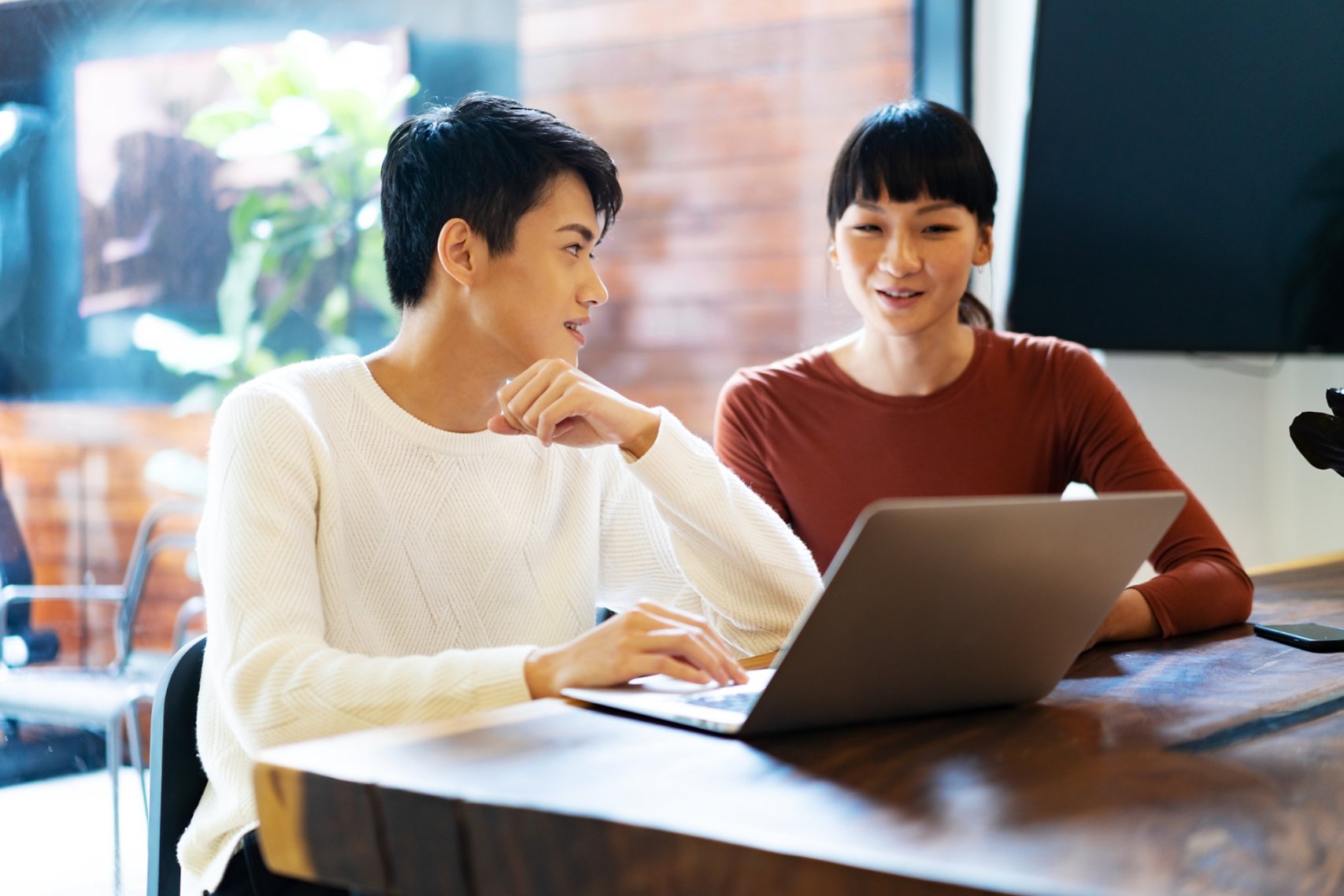 young chinese business people working with laptop