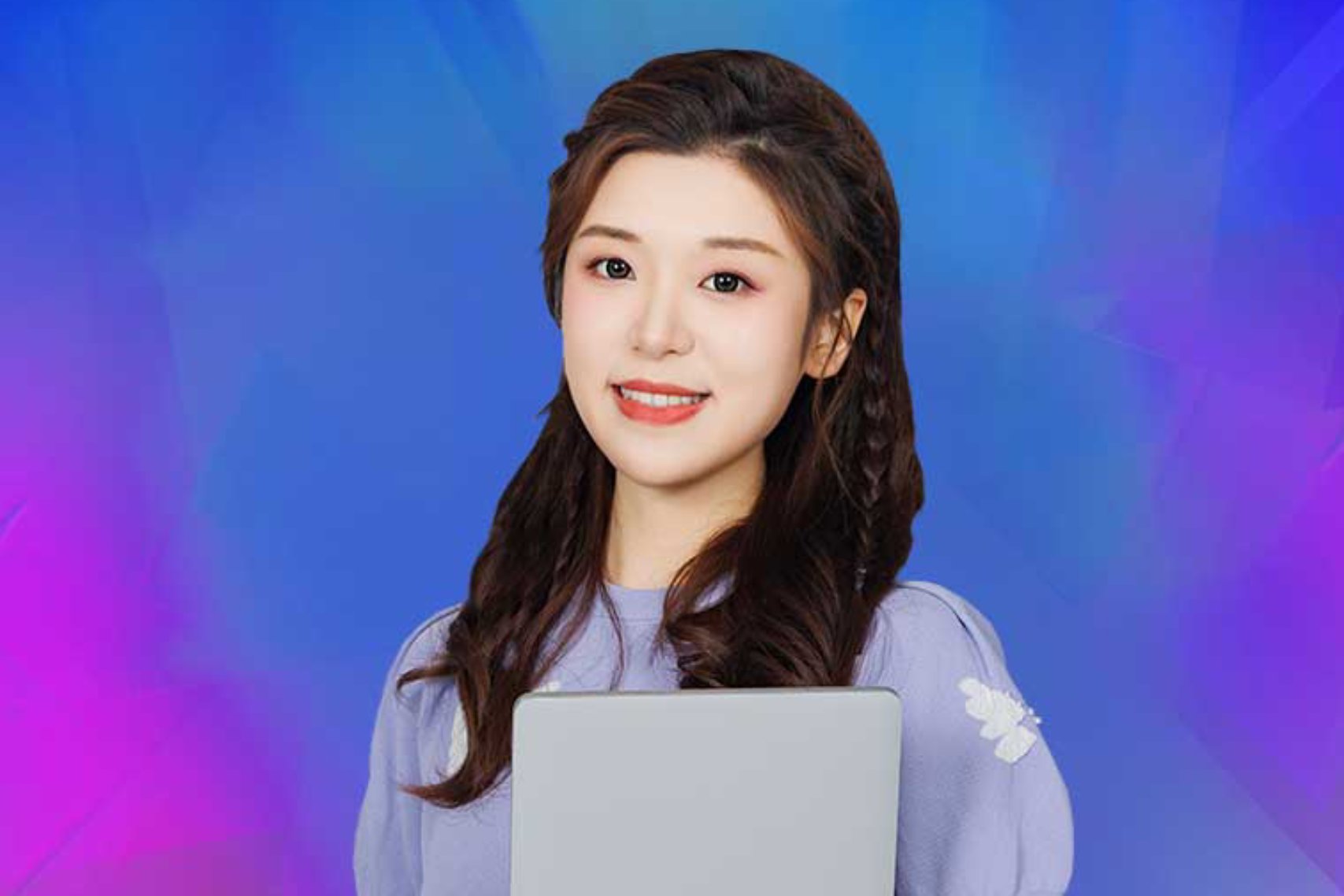 Young girl smiling while holding her laptop