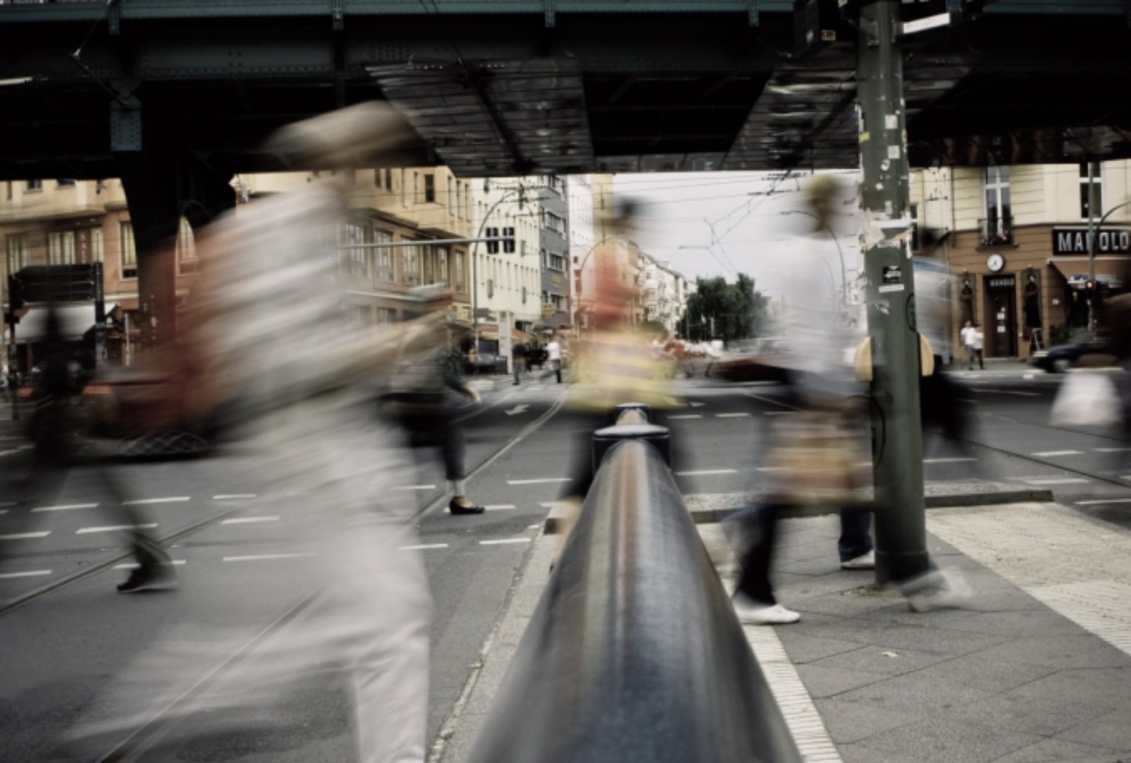 A group of people walking on a street in motion