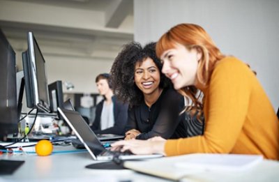 Two female colleagues in office working together