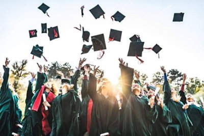 Graduates throwing graduation caps