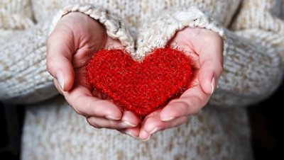 Hand holding a crocheted heart