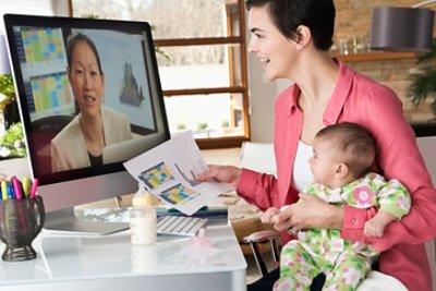  Mother holding daughter and working from home