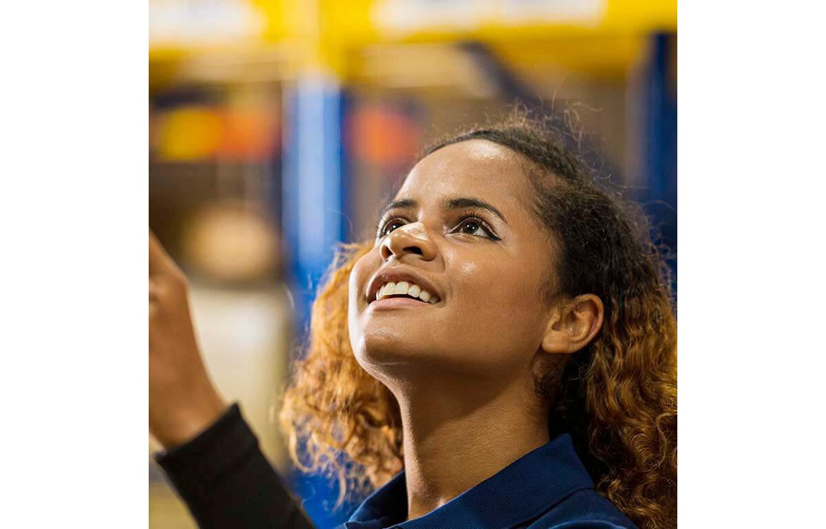 Sportswoman with prosthetic leg smiling while using mobile phone