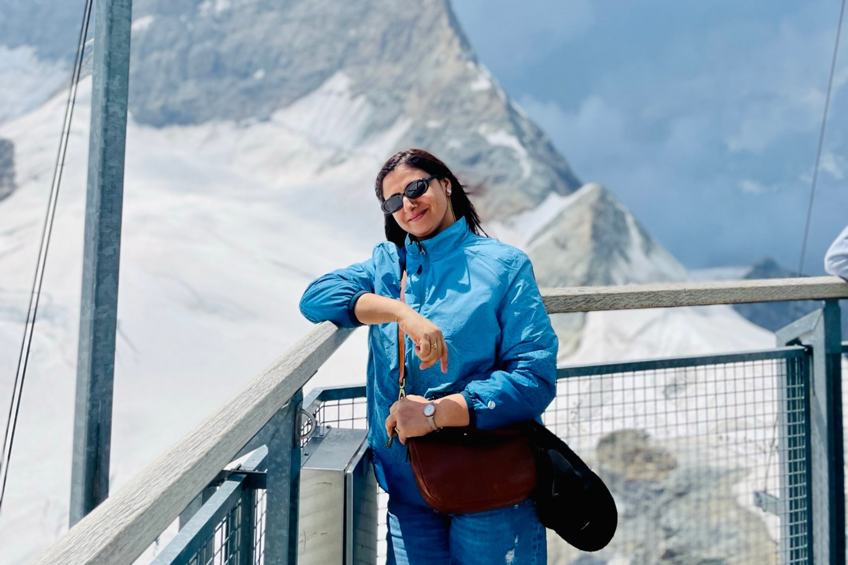 Woman pose for picture with ice mountain on the background