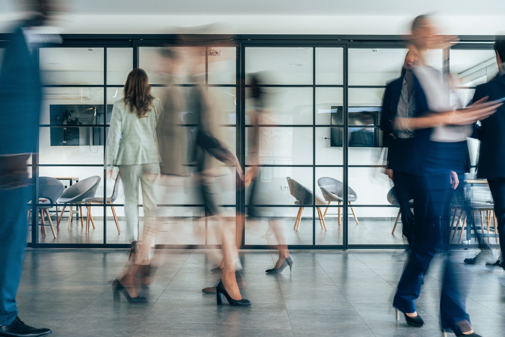 Busy modern workplace. Working process in the office, business people working, walking and talking, blurred motion