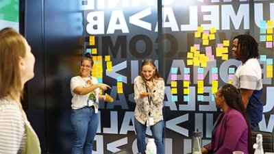 group of people with color wall