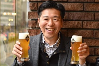 A happy man holding on his both hands a glass full of beer